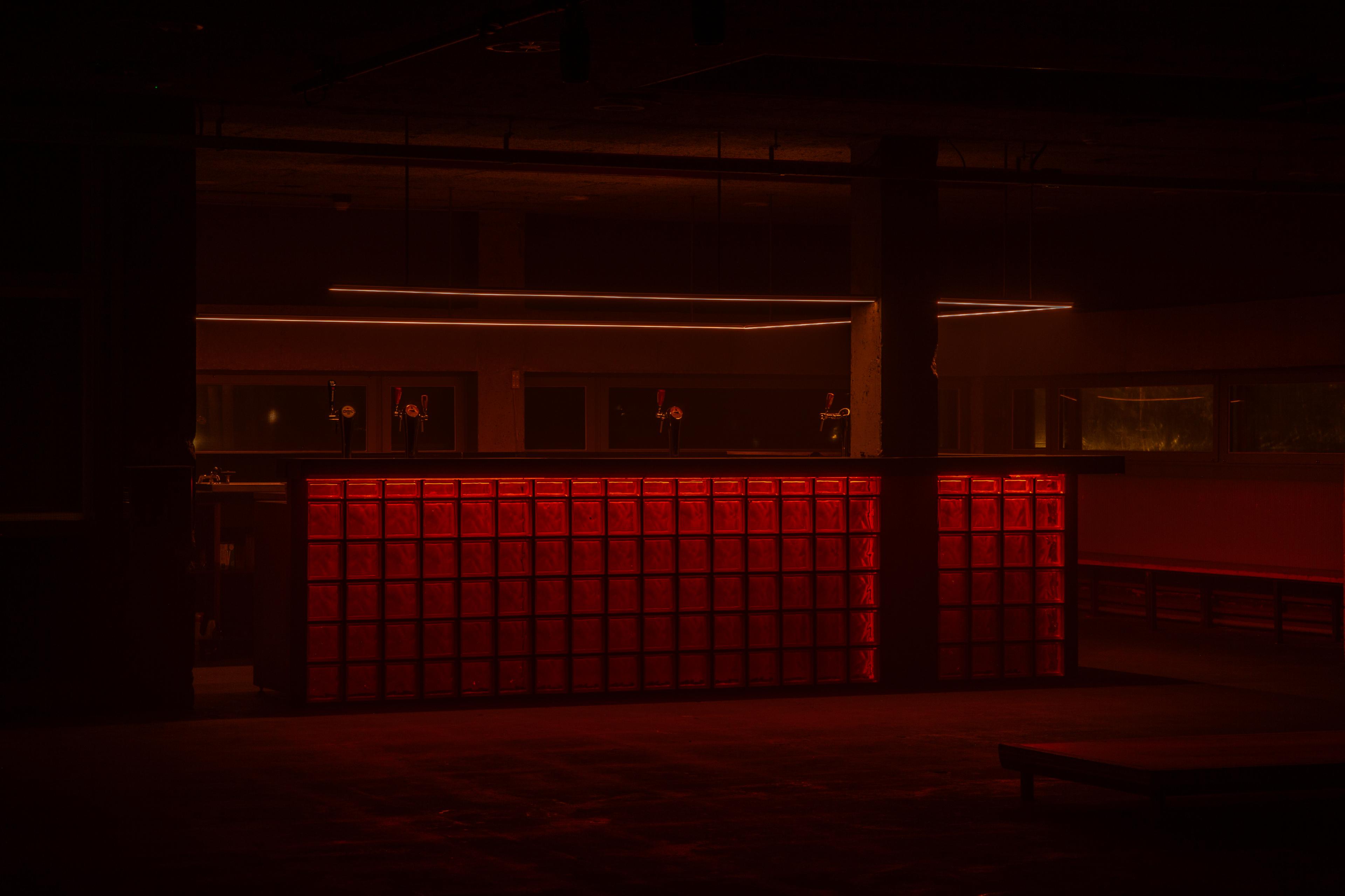 Interior with an illuminated red glass-block counter, JQN Studio, Amsterdam